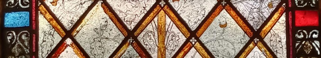 part of an 1340's window showing the incredibly detailed "pen and ink" style tracery of oak leaves and acorns.