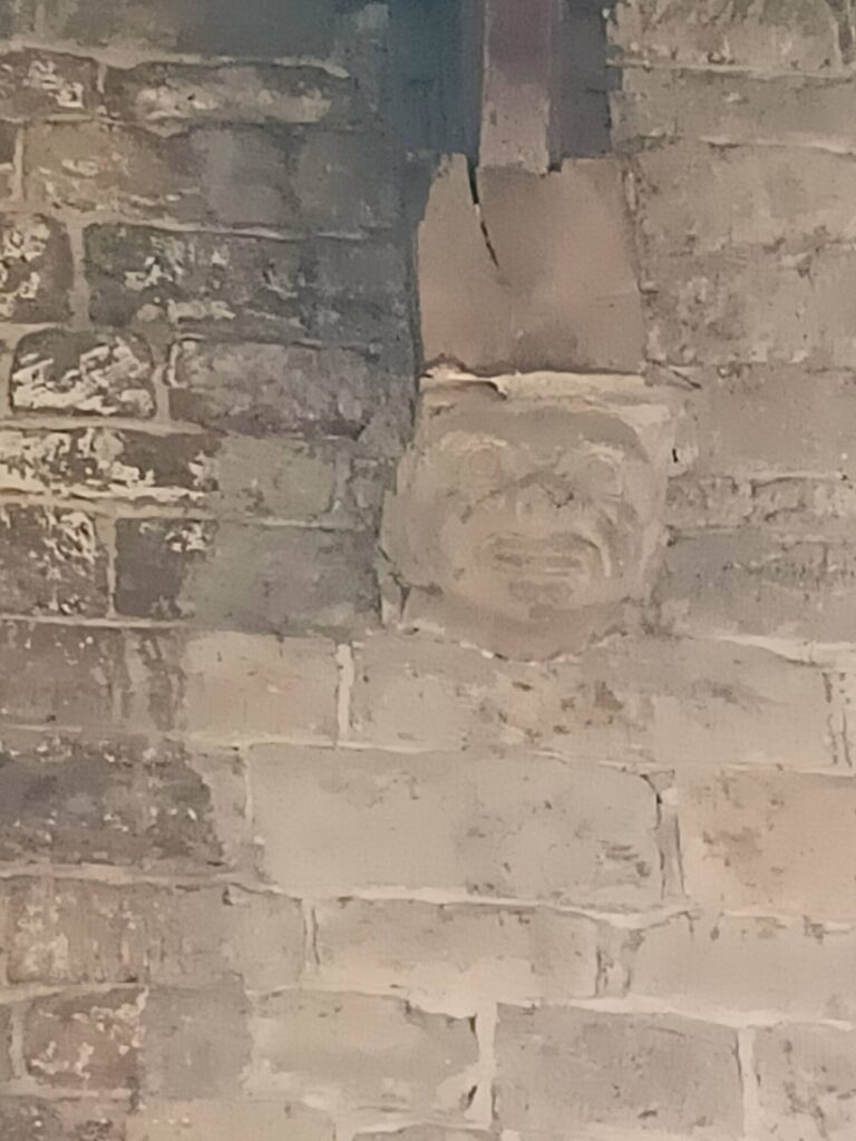 a roof corbel, carved into a grotesque