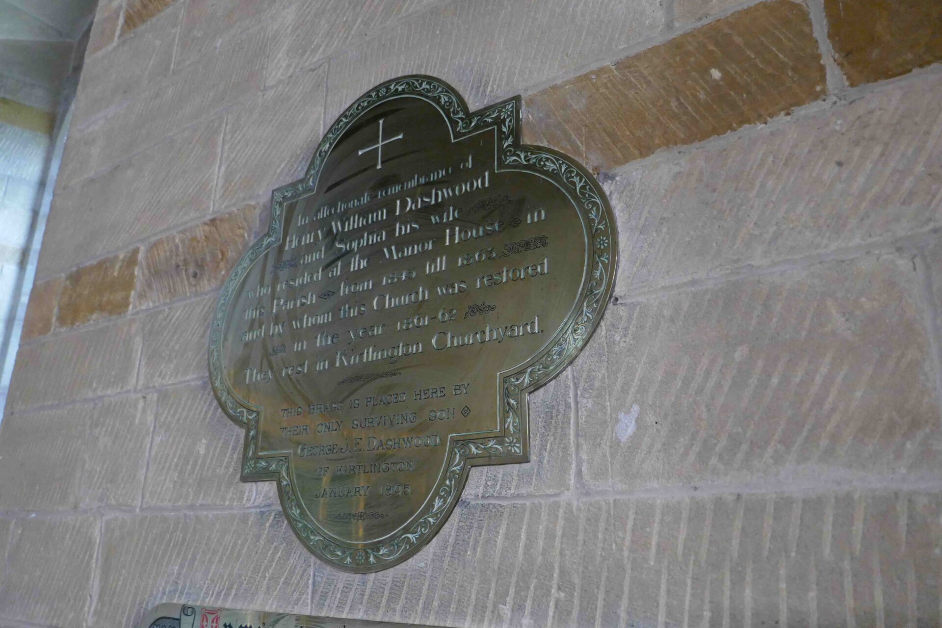 A brass memorial to one of the Dashwoods, big local landowners in history