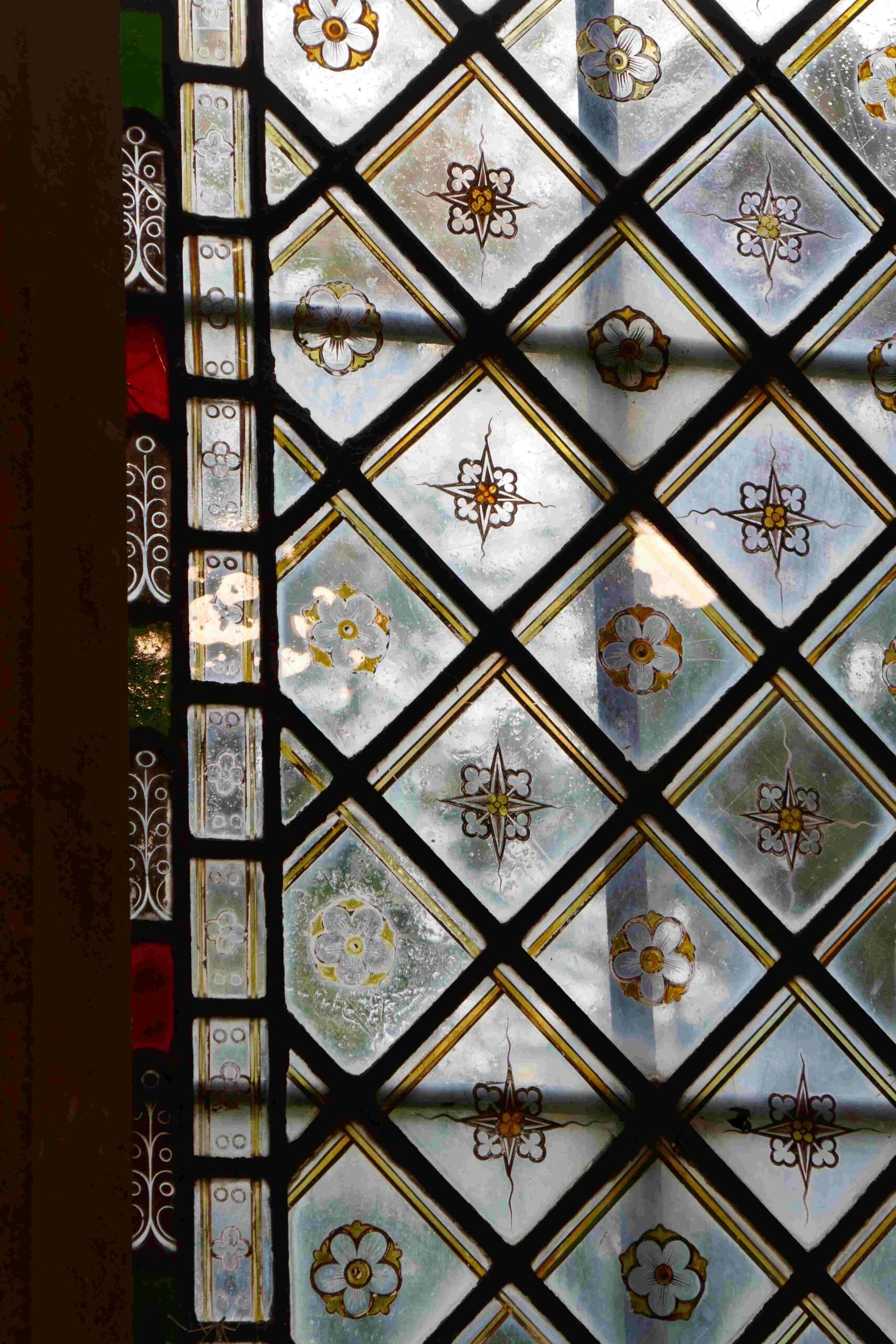 The beautiful stained glass windows, a detail - all the windows have different, beautiful designs in the stained glass.