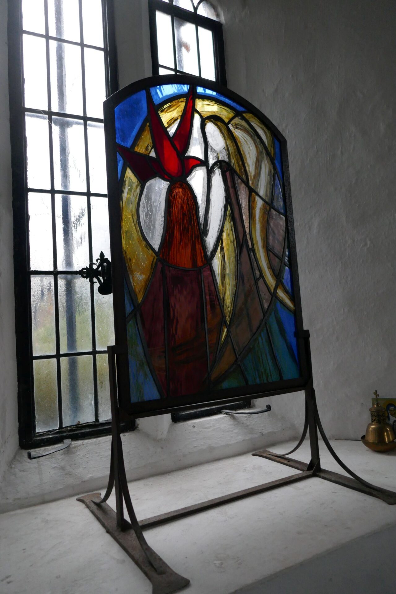 Joyous Stained Glass on the window cill with light coming through it;
