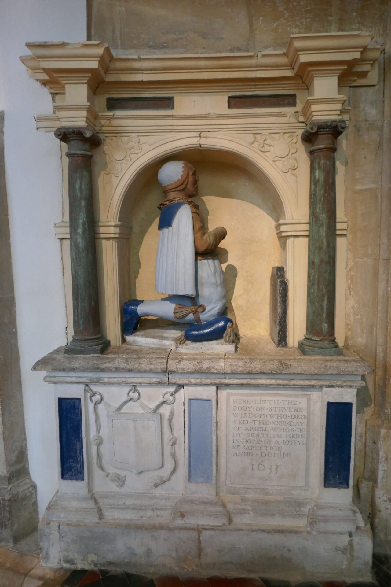 A memorial to Stephen Wisdom, 1633, kneeling at apparently his own grave marker! painted in what you hope are the original colours even if not the orginal paint!
